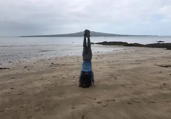 Just a handstand on one of NZ's many beaches with one of its many volcanoes in the background as well!