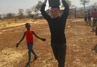 helping watering the trees at a local primary school
