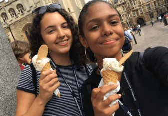 Two women with cones of ice cream.