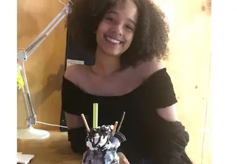 A smiling woman with a frappe.