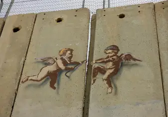 A favorite image from the trip: baby angels tearing down the concreted separation wall in Bethlehem