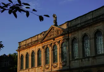 This photograph was taken while the Sun was setting on July 11th. Light and shadows cast by the Sun emphasize the beautiful architecture of Queen's College.