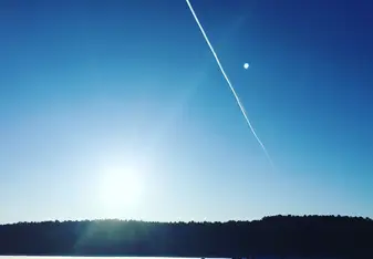 When we were skiing on a icy, quiet lake, a jet plane happened to fly by and left a long long trail. 