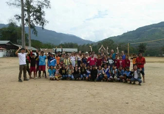 A group of people posing for a photo outdoors.