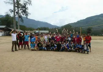 A group of people posing for a photo outdoors.