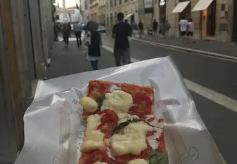 Traditional Roman pizza baked in large rectangular trays, and generally sold in rectangular or square slices by weight.