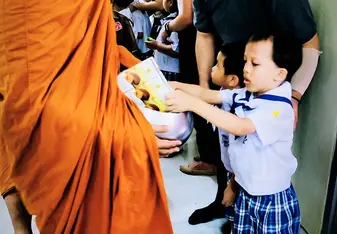 My students are encouraged to participate in donating food to the monks in our province.