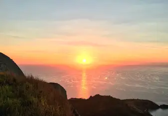 The view of the spectacular sun rising up over the vast Pacific Ocean.
