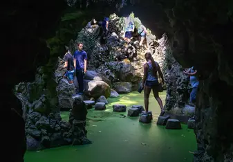 Me and a coach walking on a rock path over a green pond.