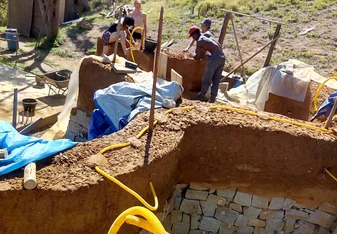 Cobbing a wall with the other volunteers