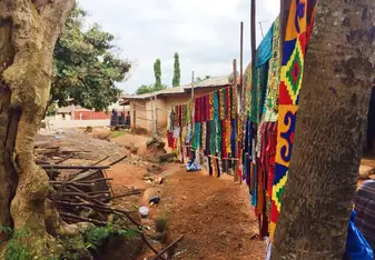 The image shows a local fabric-printing business in Ghana's Ashanti Region.