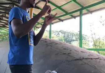 EARTH University senior Mark giving a tour explaining the biogas digester