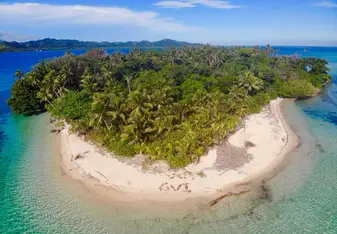 My family of diving misfits from around the world all working together to form the word GVI with our bodies on the beach for a drone picture