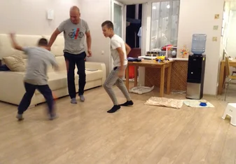 Dad and the boys play front room football