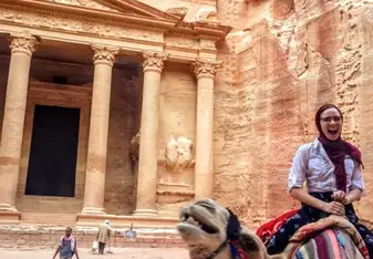 A girl (me) on riding a camel in Petra, in front of the famous Petra treasury 
