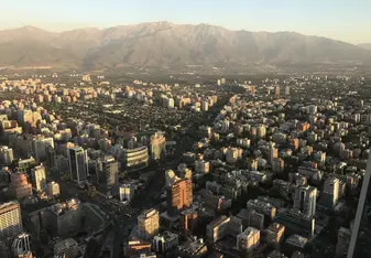 View of part of Santiago tucked in front of the nearby Andes Mountains from the top of Costanera Center, the tallest building in South America.