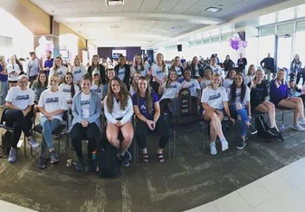 All girls sitting and smiling