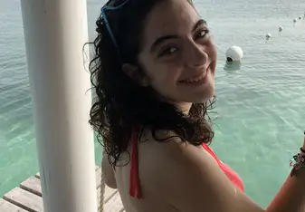 A swing overlooking very clear water in Caye Caulker