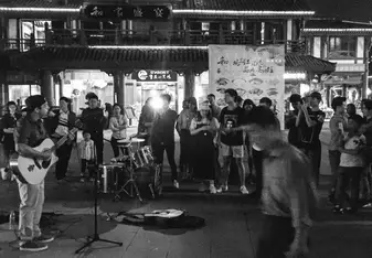 Playing music on the street in Chongqing, China.