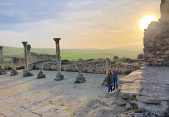 Enjoying Roman ruins in Morocoo at sunset