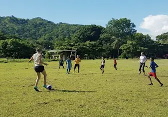 We go to play football against a local team on the most beautiful football field.