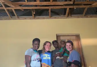 A photo of my homestay partner and I with our homestay family.