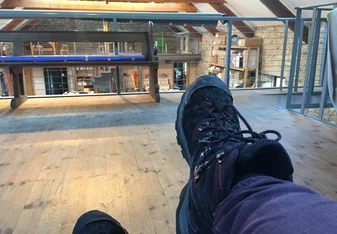 view of my feet while sitting on one of the sofas on the second floor of the barn where we do art