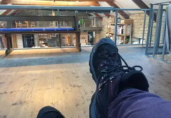 view of my feet while sitting on one of the sofas on the second floor of the barn where we do art