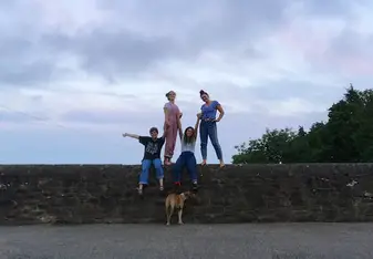 4 students standing on the wall at Cowhouse