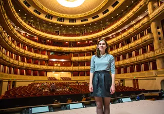 An IES Abroad Vienna student standing in one of Vienna's famous Opera Houses