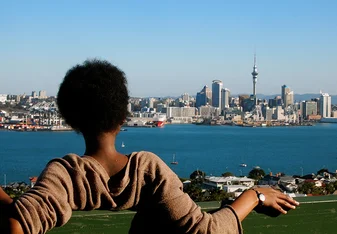 A student visiting Mount Victoria in Devonport, Auckland, looking at Auckland CBD's skyline