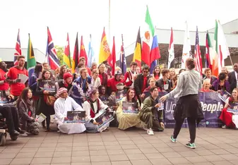 people in international costumes and flags 
