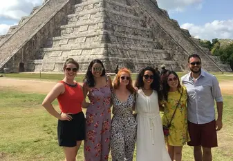 international friends standing in front of a pyramid 