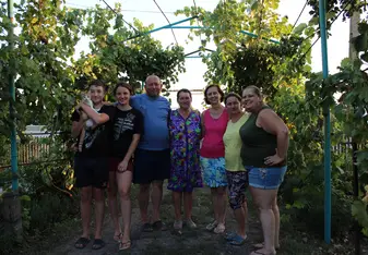 Photo of host family (including cat) and two volunteers (mom and daughter).