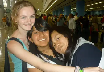 American intern hugging Mexican friends