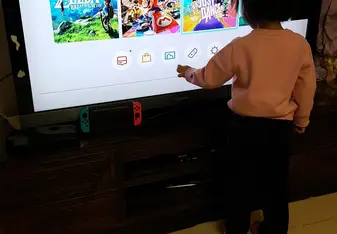 hostchild hovering before TV, exited for Just Dance 