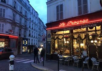 A parisienne street we wandered to, red neon lights light up a store front.  