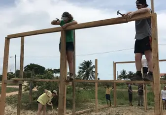 Two people working on a construction site.