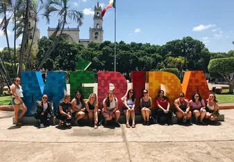Volunteer team in front of the MERIDA sign. 