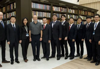 Law interns taking a group photo with their boss and collegues