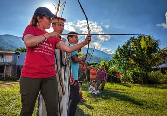 Professor Julie Madewell from Indiana University shoots and bow and arrow