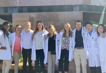My 8 fellows and I in our lab coats outside the hospital.