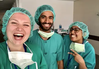 Photo in scrubs after shadowing multiple surgeries!