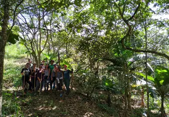Pictured is the group of volunteers I traveled with from the United States during our very first day in the agroforest!  We are all holding the tools we used to crown several trees and cut down branches so the low lying trees/plants can receive the sunlight they need to grow!