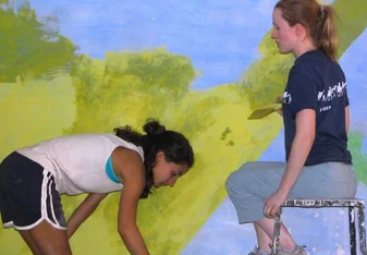 Volunteers decorating class-room walls.