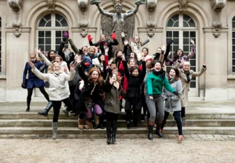 Group of students jumping during trip to Paris
