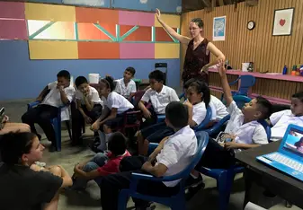 A volunteer teaching a special English class with the elementary school kids