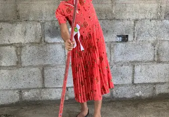 Donã Socorro's little daughter helps sweep the inside of her new home.