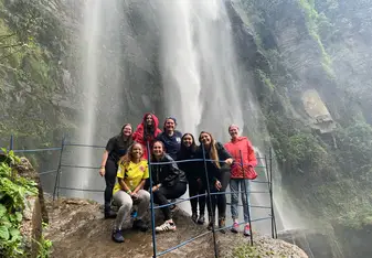 Standing below the Chorrera Waterfall in Colombia