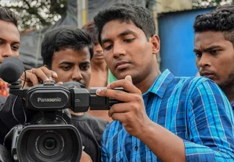 Young men using video camera